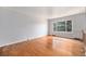 Bright living room with hardwood floors and a large window with a verdant tree view at 1244 S Wright St, Lakewood, CO 80228
