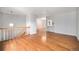 Open-concept living room with hardwood floors, staircase, and sight lines to the kitchen at 1244 S Wright St, Lakewood, CO 80228