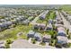 An aerial view of the neighborhood features homes with manicured lawns, mature trees, and long streets at 13822 Worthington Pl, Parker, CO 80134