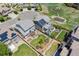 Aerial view of the landscaped backyard featuring a firepit and pergola, complete with solar panels on the roof at 13822 Worthington Pl, Parker, CO 80134
