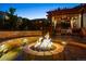 Beautiful backyard with a lit fire pit, patio area with seating, and a covered pergola for relaxing at 13822 Worthington Pl, Parker, CO 80134