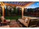 Relaxing backyard with a fire pit, patio and pergola covered seating offering an outdoor retreat at 13822 Worthington Pl, Parker, CO 80134