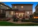 Inviting backyard with stone patio, a pergola with cafe lights, and fire pit perfect for entertaining at 13822 Worthington Pl, Parker, CO 80134
