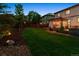 Expansive backyard with lush lawn, patio, pergola, and firepit offers the ultimate outdoor living space at 13822 Worthington Pl, Parker, CO 80134
