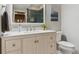 Bright bathroom features white cabinets, a marble countertop, and a modern sink at 13822 Worthington Pl, Parker, CO 80134