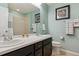 Light and airy bathroom featuring dual sinks, a large mirror, and modern fixtures at 13822 Worthington Pl, Parker, CO 80134