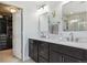 Stylish bathroom with double vanity, marble countertop, and access to a walk-in closet at 13822 Worthington Pl, Parker, CO 80134