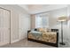 This bedroom features neutral walls, carpet, window, closet, and a daybed with decorative pillows and blanket at 13822 Worthington Pl, Parker, CO 80134