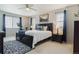 Bright bedroom features a ceiling fan, a patterned rug, and ample natural light at 13822 Worthington Pl, Parker, CO 80134