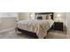 This carpeted bedroom offers a luxurious king bed with lamps, bedside table, and light colored walls at 13822 Worthington Pl, Parker, CO 80134