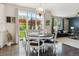 Bright dining area features hardwood floors, stylish lighting, and sliding glass doors to the backyard patio at 13822 Worthington Pl, Parker, CO 80134