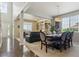Open concept dining room with dark wood table, living room, and hardwood floors at 13822 Worthington Pl, Parker, CO 80134