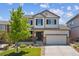 Inviting two-story home with manicured lawn, dark shutters, and a two car garage at 13822 Worthington Pl, Parker, CO 80134