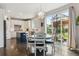 Bright kitchen and dining area with an island, stainless steel appliances, and access to the outdoor patio at 13822 Worthington Pl, Parker, CO 80134