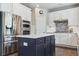 Bright modern kitchen featuring stainless appliances, white cabinets, and a center island at 13822 Worthington Pl, Parker, CO 80134