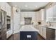 Bright modern kitchen featuring stainless appliances, white cabinets, and a center island at 13822 Worthington Pl, Parker, CO 80134