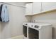 Convenient laundry room with a washer, dryer, and overhead cabinets at 13822 Worthington Pl, Parker, CO 80134