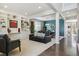 Open-concept living room with built-in shelving, a dining area, and hardwood floors at 13822 Worthington Pl, Parker, CO 80134