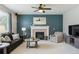 Inviting living room with a cozy fireplace, comfortable seating, and ample natural light at 13822 Worthington Pl, Parker, CO 80134