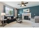 Comfortable living room with a fireplace, large window, and neutral décor at 13822 Worthington Pl, Parker, CO 80134