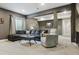Comfortable living room features a sectional sofa, an armchair, and neutral carpeting at 13822 Worthington Pl, Parker, CO 80134