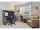 Bright office with a desk, chair, and a comfortable seating area near the window at 13822 Worthington Pl, Parker, CO 80134