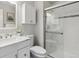 Bathroom featuring a shower with glass doors, cabinet storage, and modern finishes at 836 S Vance St # E, Lakewood, CO 80226