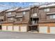 Exterior of townhouse style condo with brick and wood facade at 836 S Vance St # E, Lakewood, CO 80226