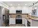 Well lit kitchen featuring stainless steel appliances, light countertops, and decorative tile backsplash at 836 S Vance St # E, Lakewood, CO 80226