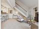 Spacious open-concept living area with barstool seating, fireplace, staircase, and modern décor for entertaining at 836 S Vance St # E, Lakewood, CO 80226