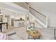 Bright open-concept living space with barstool seating, fireplace, staircase, and modern decor for entertaining at 836 S Vance St # E, Lakewood, CO 80226