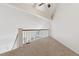 Carpeted loft space with staircase and natural light, offering versatility for a home office or sitting area at 836 S Vance St # E, Lakewood, CO 80226