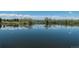 Scenic pond reflecting trees under a blue sky with puffy clouds, surrounded by lush greenery at 836 S Vance St # E, Lakewood, CO 80226