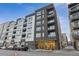 Modern building featuring a sleek facade with large windows and balconies, creating a vibrant urban living space at 1735 Central St # 208, Denver, CO 80211
