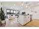 Open floor plan with modern kitchen island, stainless appliances, and stylish living area at 1735 Central St # 208, Denver, CO 80211