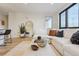 Bright living room showcasing a sectional sofa, large windows, and natural light at 1735 Central St # 208, Denver, CO 80211