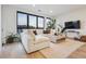 Bright living room with large windows, comfortable sectional, and stylish decor at 1735 Central St # 208, Denver, CO 80211