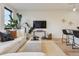 Bright living room features hardwood floors, minimalist decor, and an open layout at 1735 Central St # 208, Denver, CO 80211