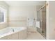 Bathroom with a corner bathtub and walk-in shower at 5272 Country Club Dr, Larkspur, CO 80118