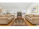 Living room with hardwood floors, fireplace, and view from large windows at 5272 Country Club Dr, Larkspur, CO 80118