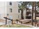 Apartment building with tidy landscaping, stairway leading up to the units, and mature shade trees at 9700 E Iliff Ave # G70, Denver, CO 80231