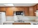 Kitchen featuring wood cabinets, stainless steel sink, and a microwave at 9700 E Iliff Ave # G70, Denver, CO 80231