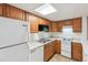 Bright kitchen features wood cabinets, white appliances, and tile flooring at 9700 E Iliff Ave # G70, Denver, CO 80231