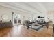 Bright and airy living room featuring hardwood floors, modern decor, and sliding glass doors to a private balcony at 9700 E Iliff Ave # G70, Denver, CO 80231