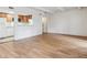 Hardwood flooring in the living room with a view to the kitchen with bright lighting at 9700 E Iliff Ave # G70, Denver, CO 80231