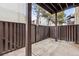 Outdoor patio space with a wood fence, concrete floor, and wooden support beams at 9700 E Iliff Ave # G70, Denver, CO 80231