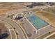Aerial view of the community tennis and pickleball courts and amenity center. Multiple parking spaces available at 14373 Shasta Daisy Pt, Parker, CO 80134