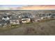 Aerial view of the home in a suburban neighborhood with fenced yards and mountain views in the distance at 14373 Shasta Daisy Pt, Parker, CO 80134