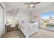 Bright bedroom with a butterfly-themed decor, cozy bed, and ample natural light from a large window at 14373 Shasta Daisy Pt, Parker, CO 80134