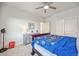 Well-lit bedroom featuring plush carpeting, a ceiling fan, and sliding closet doors at 14373 Shasta Daisy Pt, Parker, CO 80134